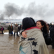 Protesters hug. (AP Photo/James MacPherson)